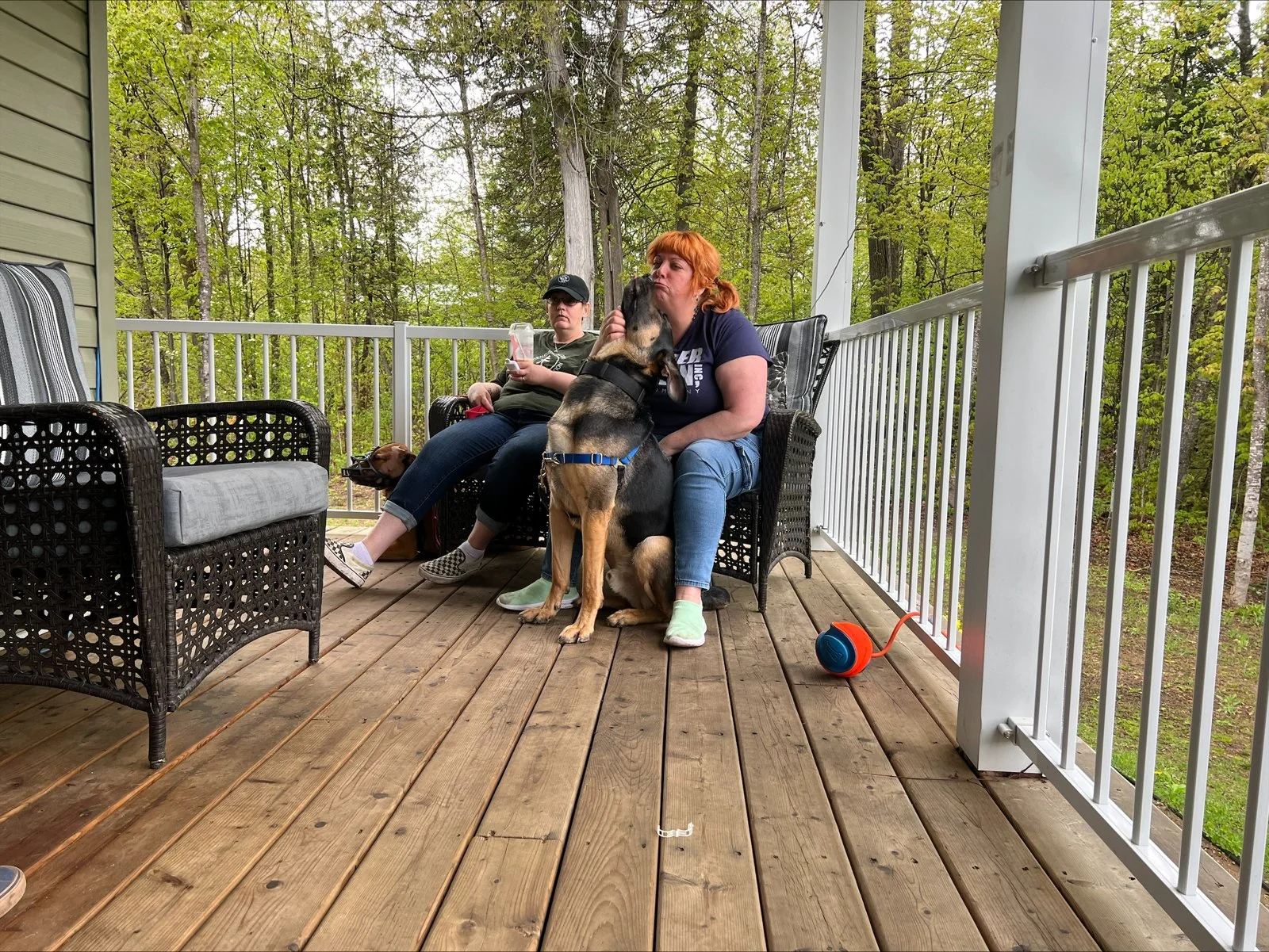 Jon and Nancy with dogs in a backyard