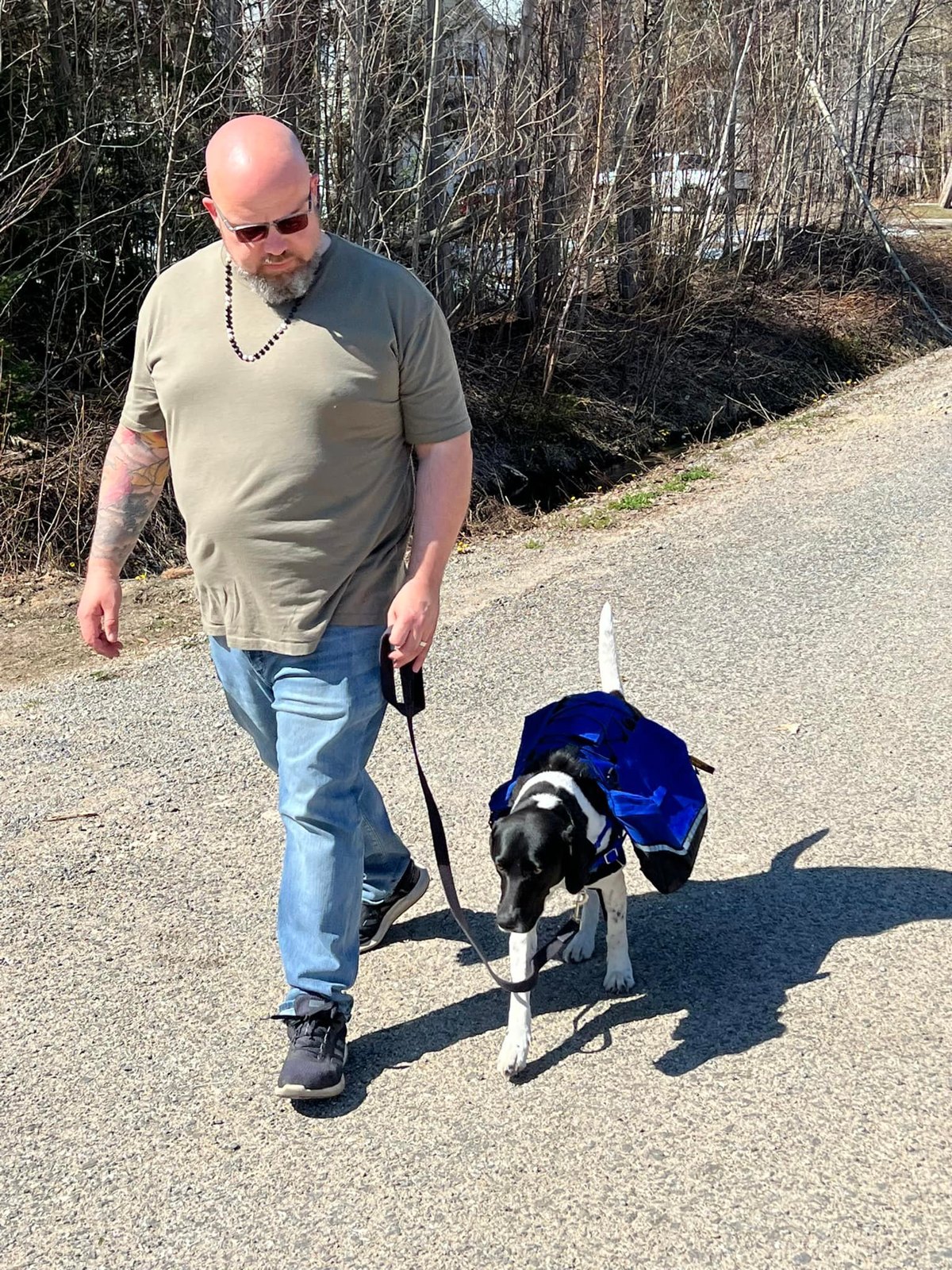 Jon Wells walking with a dog
